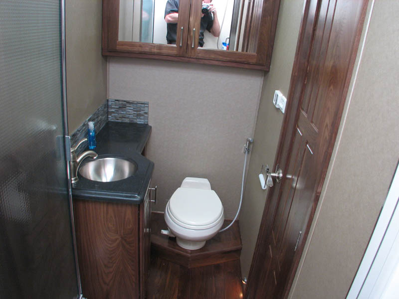 Toilet, sink, and shower located driver's side of the hallway